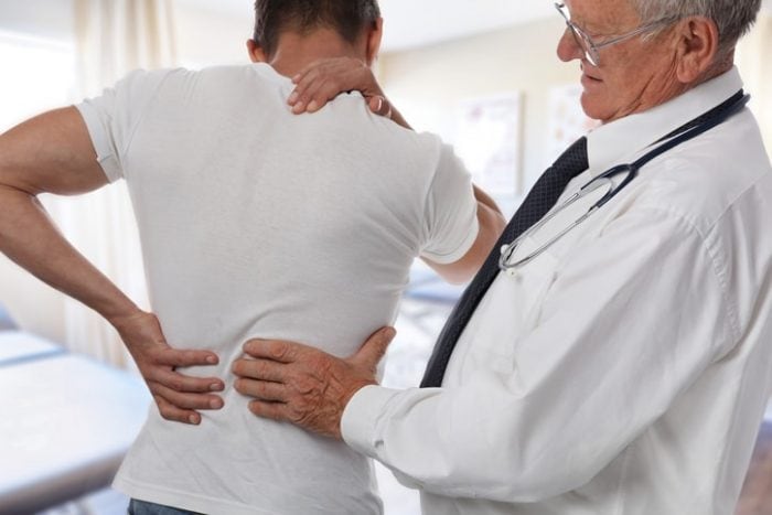 doctor inspecting back pain