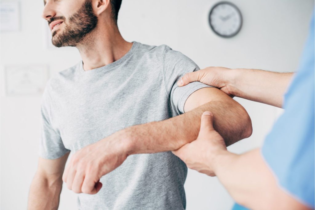 Orthopedic doctor checks elbow injury